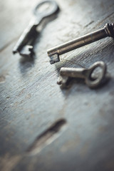 Shallow DOF. Set of vintage worn out keys on a wooden background.