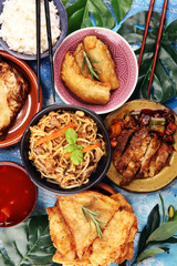 Assorted Chinese food set. Chinese noodles, fried rice, peking duck, dim sum, spring rolls. Famous Chinese cuisine dishes on table. Chinese restaurant