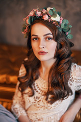 Beautiful confident woman portrait with wreath of flowers in her hair