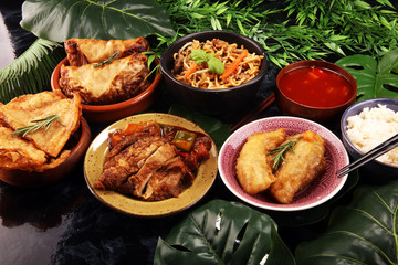 Assorted Chinese food set. Chinese noodles, fried rice, peking duck, dim sum, spring rolls. Famous Chinese cuisine dishes on table. Chinese restaurant