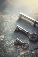 Shallow DOF. Set of vintage worn out keys on a wooden background.