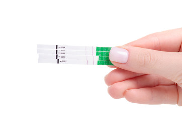 Obraz premium Ovulation tests positive in hand on a white background. Isolation