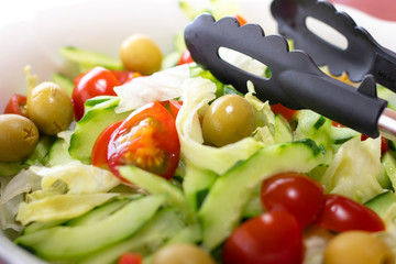 Olive salad with tongs