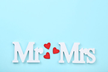 White letters Mr and Mrs with red hearts on blue background