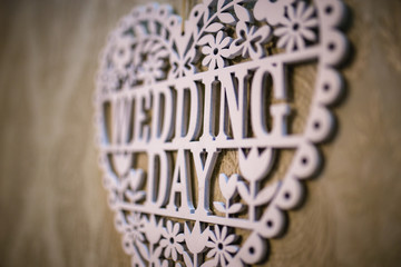 Lettering the wedding day with white wooden letters. Background for the wedding day