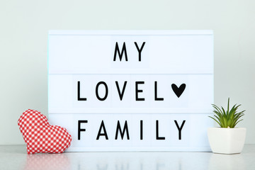 Lightbox with words My Lovely Family on grey background