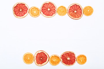 Dried citrus fruits on white wooden table