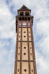 Fototapeta na wymiar Bell tower in Mede (PV), with cloudy sky on background