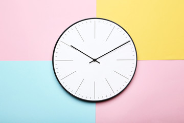 Round clock on colorful background