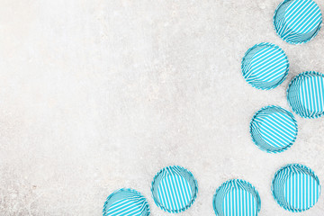 Blue cupcake cases on grey background