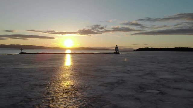 Strafing across the frozen lake in Burlington, Vermont revealing the lighthouse.