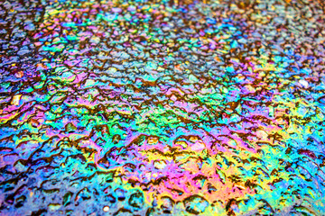 Fototapeta na wymiar Oil Petrol Pollution Rainbow Spill on A Road
