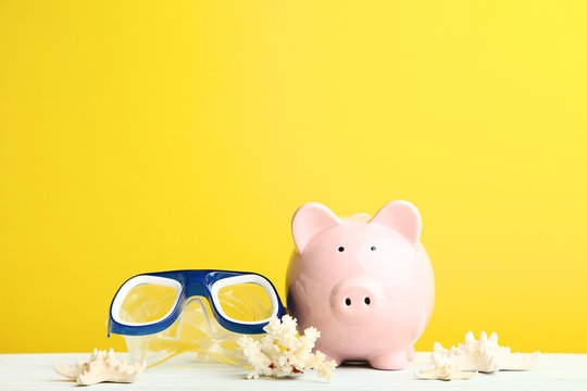 Pink Piggy Bank With Diving Mask And Snorkel On Yellow Background