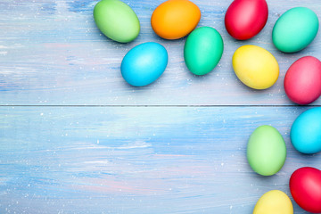 Colorful easter eggs on blue wooden table
