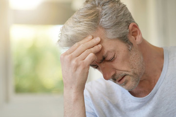 Fototapeta premium Mature man with bad headache at home