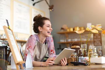 Young woman using digital tablet in coffee shop