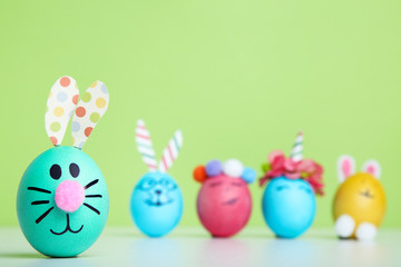 Fototapeta na wymiar Cute easter eggs on green background