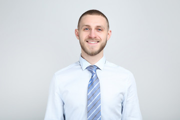 Portrait of young man on grey background