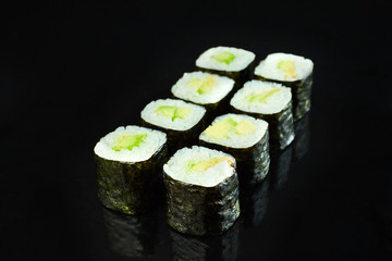 Classical vegan roll sushi maki with avocado isolated on black background for menu. Japanese food