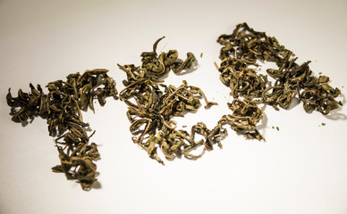 inscription tea from green tea leaves on a white background