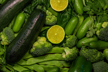 Fresh green mix vegetables: cucumber, spinach, broccoli, zucchini, parsley, bell pepper (paprika), green beans and lime. Green color pattern 