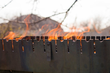 Obraz premium Beautiful red fire from wood. Flames fires preparation for cooking barbecue. Brazier on nature bbq