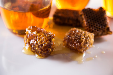 Honey in jar with honey dipper on wooden background