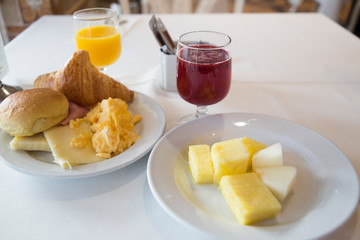 Breakfast with orange juice fruit and omelette with croissants