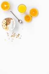 food for healthy breakfast with granola and fresh orange juice on bright white background top view mock up