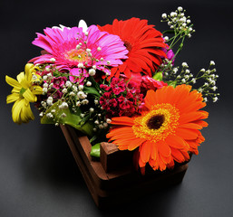 bouquet of flowers in a vase on black background