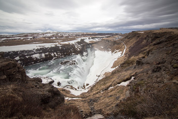 Fototapeta na wymiar Amazing Icelandic winter landscape of majestic waterfall of frozen Gullfoss