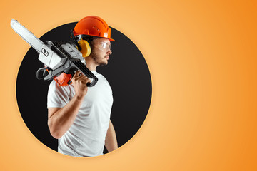 Bearded man in a helmet holds a chainsaw on an orange background. Construction concept, contractor,...