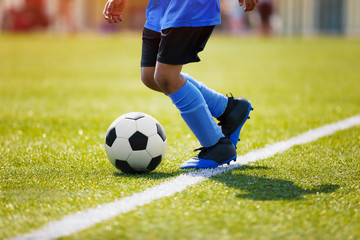 Obraz premium Teenagers Boys Playing Soccer Football Match. Young Football Players Running and Kicking Soccer Ball on a Soccer Pitch.