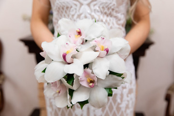Beautiful  wedding bouquet of flowers in the hands of the bride
