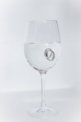 Wedding rings in full champane glass 