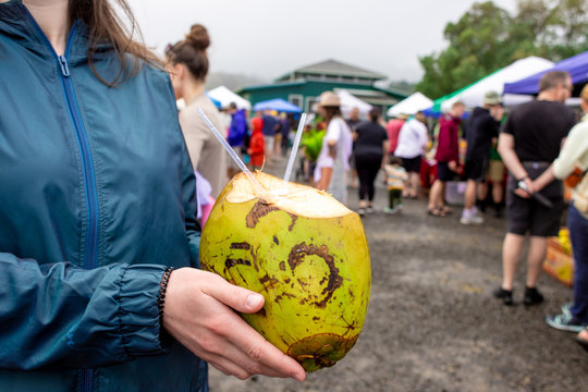 Female Hand With A Coconut On Farmers Market