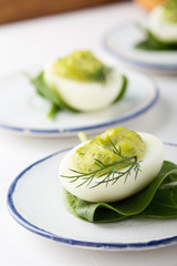 Deviled eggs with avocado and spinach on festive Easter table