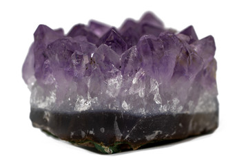 Cute druse or geode of amethyst gemstone isolated side view