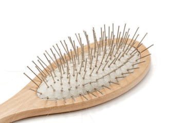 Wooden hair brush on white background. Studio shot.