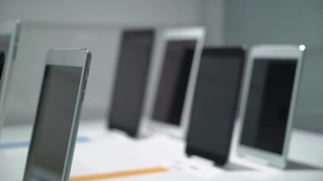 Tablets at showcase under glass in a store