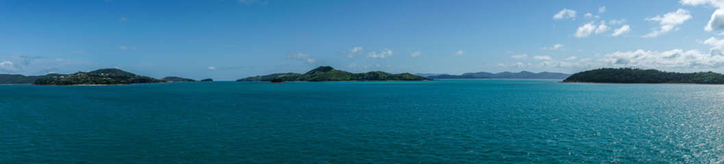 Whitsunday Island, Australia - February 16, 2019: Wide panorama shot of Whitsunday Island group with Hamilton Island to the left and Whitsunday in center. Azur sea and blue sky.