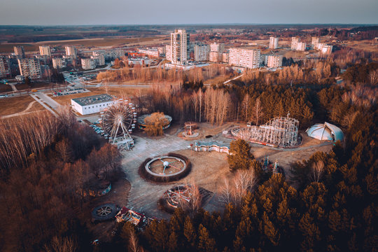 Abandoned carousel park and panorama of Elektrenai city. This abandoned park is in Elektrenai city in Lithuania, but feels like being in Chernobyl. Drone photo.