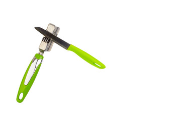 Knife, kitchen tools and knife sharpener isolated on white background. Selective focus and crop fragment