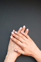 Woman's hands with pastel pink manicure