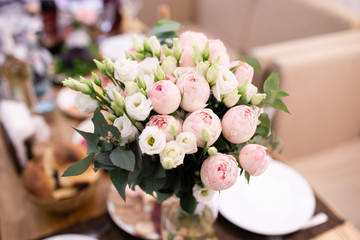 Wedding table in a restaurant with flower composition