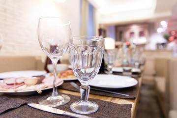 Served table in a restaurant with glasses, napkins and cutlery