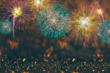 Abstract celebration background with colorful fireworks and bokeh lights.
