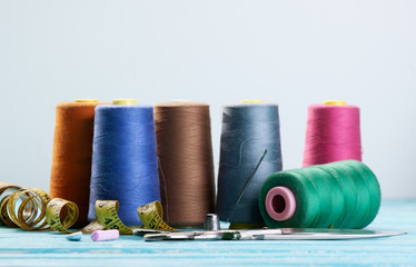 threads in coils on the background of wooden painted boards