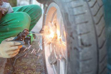 Man work with welding. Mechanical tools for auto service and car repair in Car repair shop and...