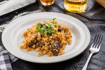 Grilled lamb with saffron rice on black table